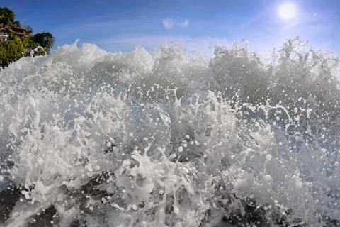Big wave front with bubbles and splashes Stock Photos