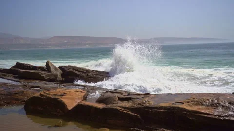 A big wave hit beachrocks hard and make big splashes in slow motion Stock Footage 296688960