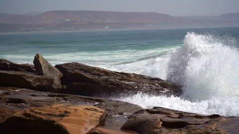 A big wave hit beachrocks hard and make big splashes in slow motion Stock Footage 296688967