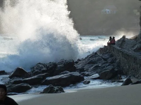 Big wave on rocks Stock Photos