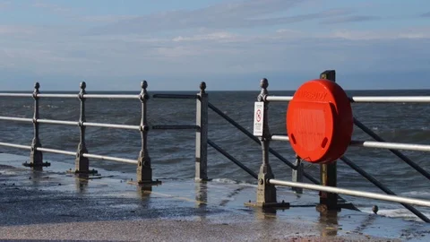 Big wave splashes on a life ring in Whitby, England. Video stock 69838359
