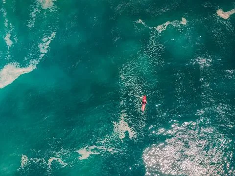 Big wave surfer in ocean waiting wave. Aerial view Stock Photos
