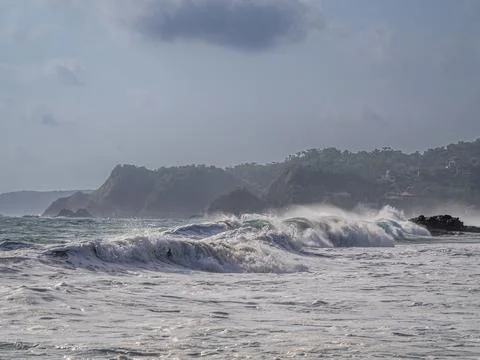 Big waves against the background of forested hills Stock Photos