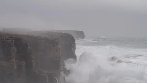 Big waves in the Atlantic slamming into the towering cliffs of Sagres Stock Footage 327837388