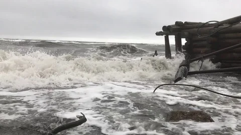Big waves beat on the logs of the old jetty. Stock Footage 80091466