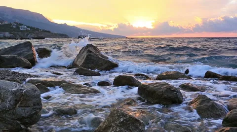 Big waves break about stones at sunrise Video stock 47676042