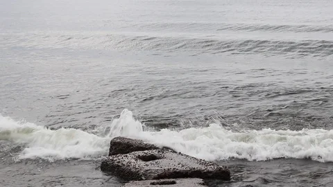 Big waves break on a concrete stone pier in a storm on Lake Baikal in a big sea Stock Footage 110626097