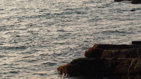 Big waves break on the rocky shore Stock Footage 126842545
