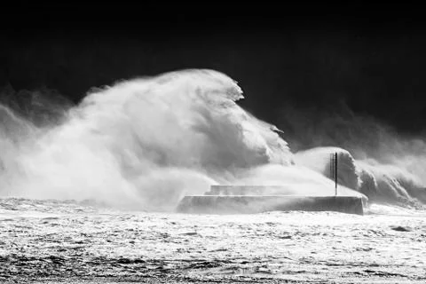 Big waves breaking on breakwater Stock Photos