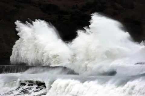 Big waves breaking on breakwater Stock Photos