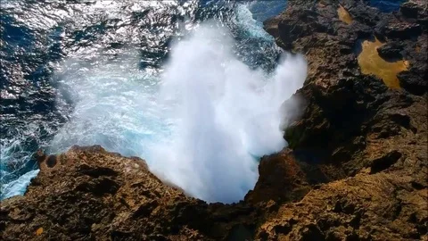 Big waves clashing rocks/mountain creating an awesome big splash Stock Footage 84051163