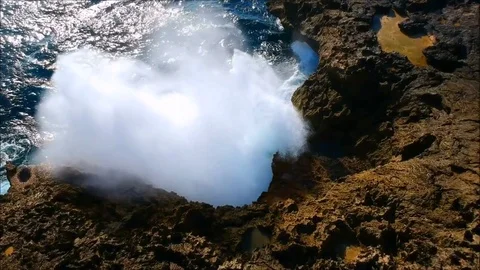 Big waves clashing rocks/mountain creating an awesome big splash 2 Stock Footage 84051763