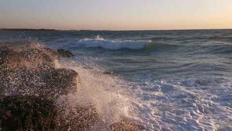 Big waves crash against the rocks. Storm at sea at sunset 스톡 동영상 145273229
