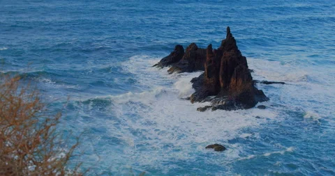 Big waves crash into the black volcanic rocks on the remote shore of Tenerife Stock Footage 200529956