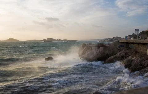 Big waves crash on the rocks of the Corniche of Marseille Stock Photos