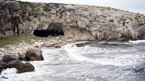 Big waves crash on the rocky wild beach. Stock Footage 220153961