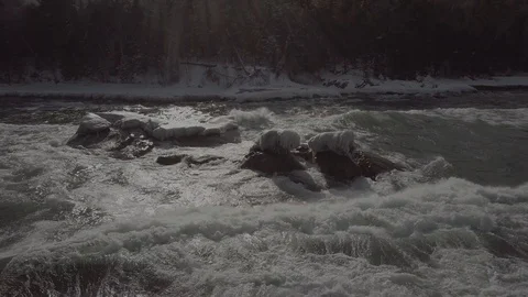 Big waves crashing on ice covered rock Stock Footage 86546053