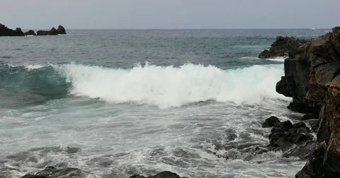 Big waves crashing on stone beach Stock Footage 80262531