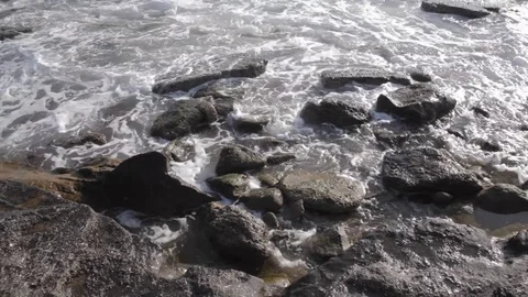 Big waves crashing on stone beach Stock Footage 83206137