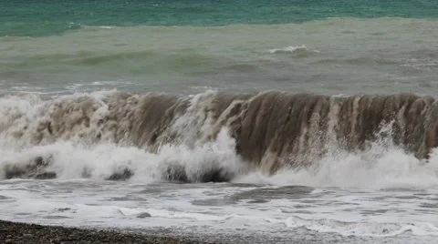Big waves in the dark sea breaking on the shore with the formation of spray Stock Footage 62890632