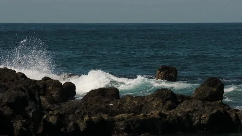 Big waves hit the rocks on the coastline in a slow motion Stock Footage 309172518