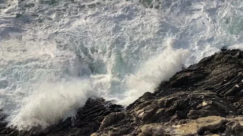 Big waves hitting on the rock, top-down view Video stock 263258920