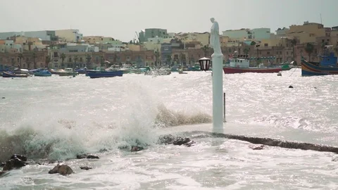 Big waves hitting a statue on windy day. Stock Footage 108855729
