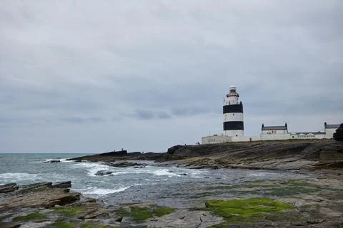 Big waves hitting stones at hook lighthouse. Wexford, Ireland Stock Photos