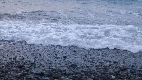 Big waves passes in calm ocean along the west coast of Norway. Pebbles small sto Stock Footage 162152265