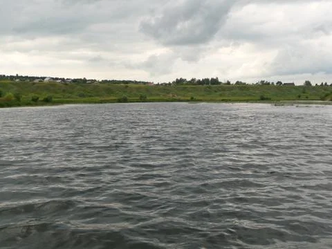 Big waves on the river on a cloudy day. Stock Photos