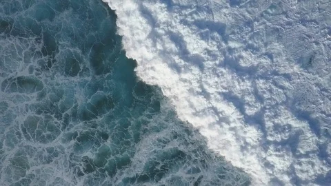 Big waves rolling in overhead top down drone aerial view. Huge breaking swell Video stock 103427618