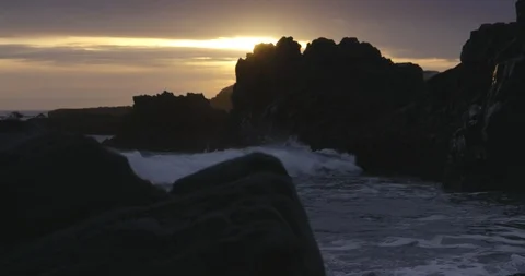 Big waves splashing against the rocks in the sea at sunset 스톡 동영상 103807107