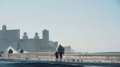 Big waves. Two intrepid go along the coast of Havana. Stock Footage 72486443