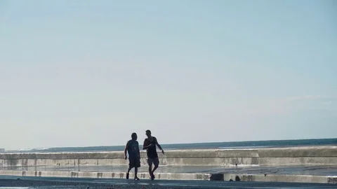 Big waves. Two intrepid go along the coast of Havana. Stock Footage 72486902