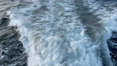 Big waves on water surface with white foam from moving ship in ocean Stock Footage 279594763
