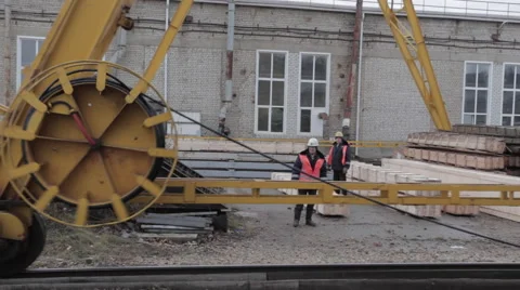 The big wheel of rail crane with two workers background Stock Footage 62083189