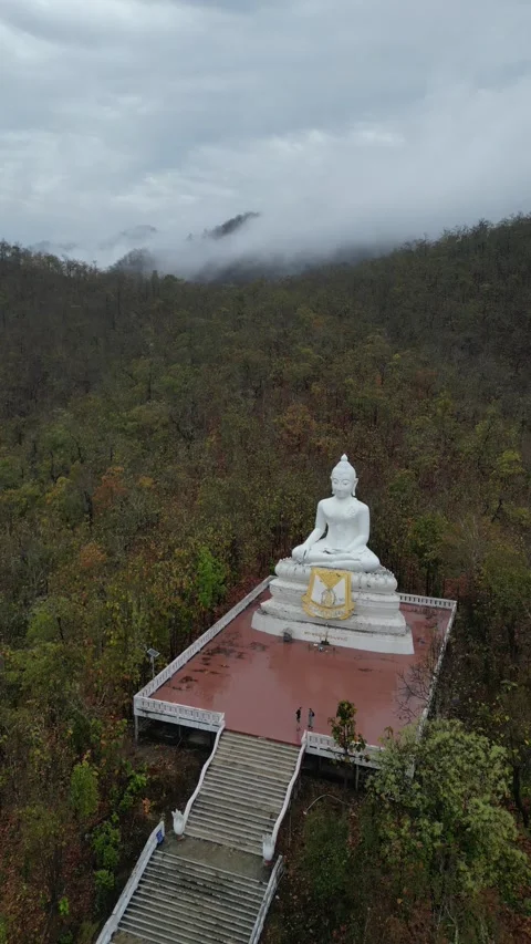 Big White Buddha Statue Meditating in a Mountainous Forest Landscape in Pai, Mae Stock Footage 335601080