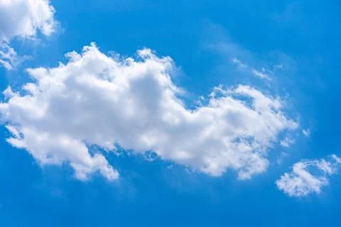 Big white cloud floating on vast blue sky in beautiful weather Stock Photos