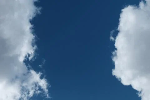 Big white clouds in the blue sky Stock Photos