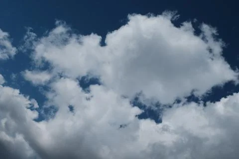 Big white clouds in the blue sky Stock Photos
