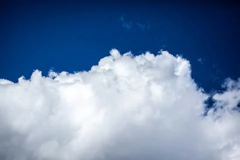 Big white clouds in a blue sky close-up. There is a place for the text Stock Photos