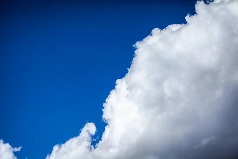 Big white clouds in a blue sky close-up. There is a place for the text Stock Photos
