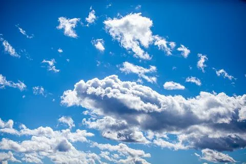 Big white clouds in a blue sky close-up. There is a place for the text Stock Photos