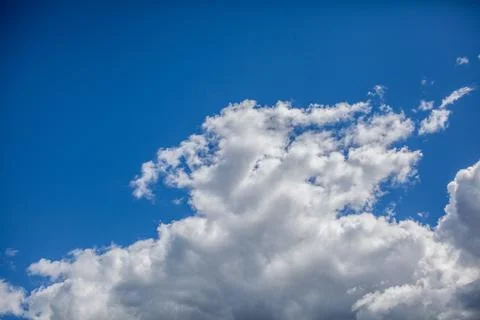 Big white clouds in a blue sky close-up. There is a place for the text Stock Photos