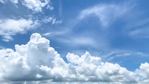 Big white fluffy clouds and bright blue sky on summer season Stock Footage 218339972