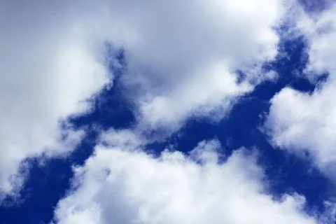 Big white fluffy clouds in the blue sky.Summer background. Stock Photos