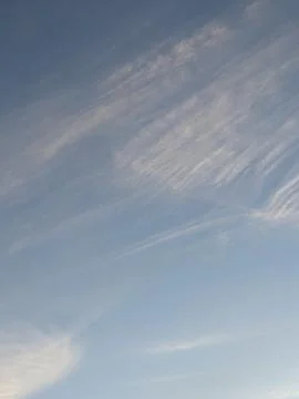 Big White Fluffy Clouds on A Blue Sky With Fine Whispy Lines Stock Photos