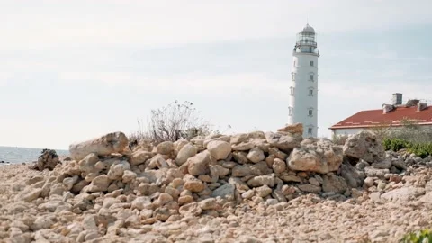 Big white lighthouse on the shore Stock Footage 171787557