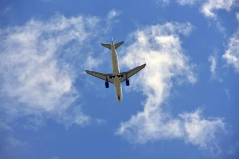 Big white passenger plane in blue sky Stock Photos