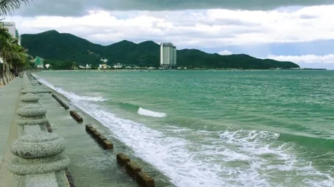 Big white waves hitting dyke on the shore in Nha Trang city Stock Footage 165806961